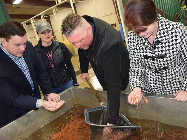 Ben Gollon shows his bait facility to Wisconsin Senator Patrick Testin and others.